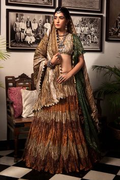 Multicolored gota tissue textured lehenga with bronze, rust and antique gold panels. Paired with zardozi beige blouse, one-sided ruffled jacket.
Component: 3
Pattern: Textured
Neckline: V neck
Fabric: Gota Tissue
Color: Multi Color
Other Details: 
Textured lehenga
Tassel detail
Note: Crushed dupatta worn by the model is not for sale
Occasion: Sangeet, Destination Wedding - Aza Fashions Brown Lehenga With Dupatta For Wedding, Festive Brown Lehenga With Traditional Drape, Festive Brown Lehenga With Dupatta, Brown Anarkali Lehenga With Zari Work, Anarkali Style Brown Lehenga With Zari Work, Brown Bollywood Lehenga With Pallu, Bollywood Style Brown Lehenga With Pallu, Brown Anarkali Set With Dupatta For Festive Occasions, Brown Lehenga For Festivals