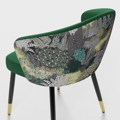 an upholstered green chair with black legs and floral print on the backrest