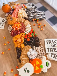 a wooden table topped with lots of halloween treats