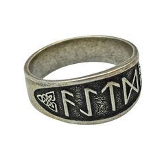 a silver ring with the word faith in black and white letters on it's side