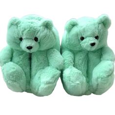 two light green teddy bears sitting next to each other on a white background with black eyes