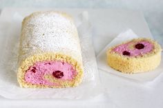 two pastries on wax paper with powdered sugar and raspberry filling