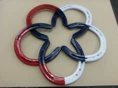 four red, white and blue horseshoes sitting on top of a piece of paper