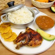 a white plate topped with chicken, rice and fruit