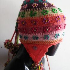 The Chullo Is A Hat With Ears Woven In Wool With Multicolored Drawings, Used In The Andean Regions To Protect Themselves From The Cold. This Chullo Is Originally From The Andean Culture Of Cusco. It Can Also Be Seen In The Pictures. It Has Designs Of Flowers And Pompoms All Around. This Piece Is Handwoven By The Peruvian Artisans Of The Andean Community Of Cusco. Multicolor Beanie Cap For Beach, Multicolor Beanie One Size For Beach, Multicolor Beanie For Beach, One Size, Multicolor Cap Beanie For The Beach, Multicolor Beanie For Beach, One Size Fits Most, Bohemian Knitted Beanie Cap, Bohemian Winter Beanie, Bohemian Knitted Beanie One Size, Multicolor Brimmed Winter Hat