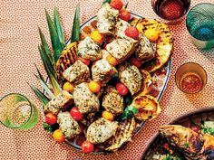 a platter filled with meat and vegetables on top of a table next to other dishes