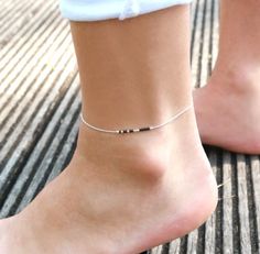 This minimalist ultra thin anklet is made with sterling silver snake chain adorned with Black miyuki beads.➵ Perfect to wear alone or for layering with more anklets.➵ More anklets : https://www.etsy.com/shop/silverbirdjewels/items?section_id=21837916--*--*--*--*--*--*--*--*--*--*--*--*--*--*--*--*--*--*--∞ SIZE ∞- length: Adjustable bracelet - around 20 cm (7,9 in) - 25 cm (9,8 in).If you like another length please make a note when you "check out" (I can make it for children) .∞ MATERIAL ∞- Ster Black Anklet, Silver Anklets Designs, Leather Anklets, Silver Ankle Bracelet, North Star Necklace, Gold Disc Necklace, Anklet Designs, Jewelry Delicate, Star Necklace Gold