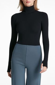 This buttery-soft turtleneck top fits like a second skin thanks to ample stretch that's blended right in. Turtleneck Long sleeves 84% nylon, 16% elastane Machine wash, dry flat Imported High Stretch Mock Neck Top For Fall, Fall Mock Neck Top With High Stretch, Chic High Stretch Mock Neck Top For Layering, Versatile Fitted Turtleneck, Solid Fitted Versatile Turtleneck, Fitted Solid Color Versatile Turtleneck, Versatile Solid Fitted Turtleneck, Black Elastane Turtleneck For Fall, Chic Stretch Mock Neck Top For Layering