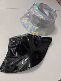 Holographic or black vinyl hat. Hats measure 23 inches Note: please measure your head. I don't appreciate bad reviews from buyers who don't measure and who don't read the measurements.  Thank you in advance. perfect for every day street wear!  Partnered design by Glitz & Candy Co.  Check them out on Facebook & Etsy! Drop-shipped by Glitz & Candy Co. Trendy Bucket Hat For Party, Trendy Party Bucket Hat, Black Hip Hop Hat For Festival, Black Hip Hop Festival Hat, Trendy Party Hat, One Size Fits Most, Trendy Short Brim Hats For Music Festival, Trendy Party Hats One Size Fits Most, Adjustable Bucket Hat For Party, Trendy Black Bucket Hat For Streetwear