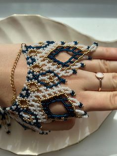 a woman's hand with bracelets made from beads and pearls on her wrist