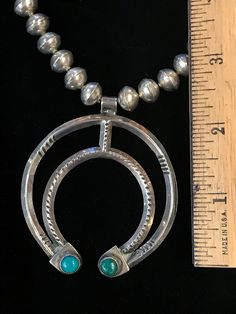 "Vintage Navajo-made sterling silver naja pendant, made around the 1930s. Pendant is 2.5\" long, 2.25\" wide, with two 0.25\" natural turquoise cabochons. The necklace is 23\" long, with handmade sterling silver beads. We ship with USPS, insured for the full value of the item." Vintage Silver Turquoise Necklace Hand-strung, Traditional Silver Turquoise Concho Necklace, Traditional Silver Turquoise Necklace With Concho, Traditional Silver Hand-strung Turquoise Necklace, Traditional Silver Turquoise Necklace Hand-strung, Traditional Hand-strung Turquoise Necklace, Unique Silver Hand-strung Turquoise Necklace, Unique Silver Turquoise Hand-strung Necklace, Unique Silver Turquoise Necklace Hand-strung