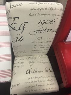 an upholstered chair with writing on it