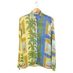 Superb statement 1990's Versace Jeans Couture shirt by Gianni Versace. The pattern depicts palm trees and nautical Miami influenced, baroque images through out. Features Central line button fasten Gold Sun embossed buttons Oversized fit Semi sheer fabric Sizing: Pit to Pit: 19'' Pit to Cuff: 19'' Nape to Hem: 28'' Recommended Size: UK Small Condition 7/10 Versace Baroque, Palm Leaf Pattern, Central Line, Palm Leaves Pattern, Versace Shirt, Gold Sun, Versace Jeans Couture, Versace Jeans, Gianni Versace