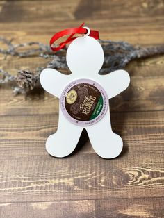 an ornament shaped like a man with a red ribbon around it's neck