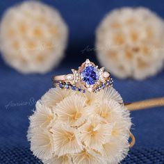 a blue ring sitting on top of a white flower