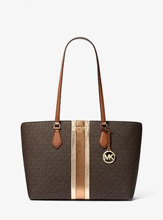 The Sheila tote is an elegant take on a timeless silhouette. Finished in our Signature logo print with a metallic snake-embossed stripe, it features a spacious interior with a center zip pocket for easy organizing. Slip it over your shoulder seven days a week. Michael Kors Eva Large Tote, Logo Tote Bag, Michael Kors Outlet, Nylon Tote Bags, Bags Logo, Easy Organization, Nylon Tote, Large Tote Bag, Black Tote Bag