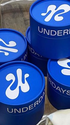 four blue containers with the words underdays written on them are stacked next to each other