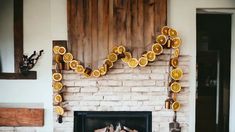 a fireplace with orange slices on the mantle