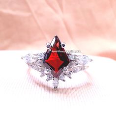 kite cut red garnet engagement ring set 14k rose gold marquise cut cubic zirconia ring for women bridal wedding ring set Specifications :- ❥ Stone - Natural Garnet  ❥ Stone Size - 7x11mm ❥ Cut Type - Kite ❥ Side stones - Simulated Diamonds Cz ❥ Ring Size: I offer more than one (Contact us if your ring size is not available in the listing) ❥ Color: Silver, Gold, Rose Gold, White Gold or Black Rhodium ❥ Material : 925 Sterling Silver, 14K/18K/22K Solid Gold --> ❥ Makes a Wonderful Gift for your Gi Elegant Marquise Cut Bridal Sets For Promise, Marquise Ruby Jewelry For Anniversary, Elegant Emerald Cut Jewelry For Valentine's Day, Red Cubic Zirconia Promise Ring, Red Cubic Zirconia Promise Ring Jewelry, Elegant Marquise Ruby Jewelry, Red Cubic Zirconia Jewelry For Promise Ring, Formal Red Marquise Cut Jewelry, Red Diamond Marquise Cut Jewelry