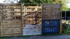 a gate made out of wooden pallets in the yard