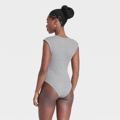 Upgrade your loungewear wardrobe with this Sleeveless Rib Bodysuit from Universal Thread™. The sleeveless bodysuit features a V-neckline and 2 X 2 ribbed construction, taking you from running errands to lunch with friends in chic style. The soft, stretchy fabric keeps you in cool comfort, while a crotch snap closure lends functional detail to your look. Pair with your favorite pair of bottoms to complete the look. Universal Thread™: Found exclusively at Target. High Stretch Sleeveless Bodysuit For Loungewear, Sleeveless Solid Color Bodysuit For Loungewear, Spring Sleeveless Ribbed Bodysuit, Sporty Seamless Sleeveless Bodysuit, Casual Seamless Short Sleeve Bodysuit, Fitted Bodysuit For Lounging, High Stretch Bodysuit For Loungewear, Casual Fitted Short Sleeve Bodysuit With V-neck, Seamless Solid Bodysuit For Lounging