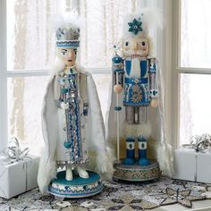 two nutcracker figurines sitting next to each other on a window sill