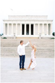 a man and woman holding hands in front of the lincoln memorial