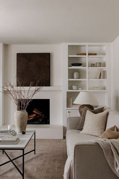 a living room filled with furniture and a fire place