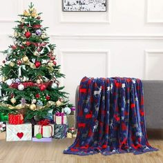 a living room with a christmas tree and presents on the floor in front of it