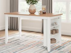 a white table with a potted plant on top and some shoes under the shelf