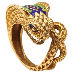 Etruscan revival cobra ring. Beautiful three dimensional ring, created with Etruscan revival patterns. This unusual cocktail ring has been sculpted in the shape of a cobra, in solid 18k yellow gold with highly textured surfaces. The sculpted piece show the cobra snake in attack and guard position with its mouth wide open and showing its fangs. The body is scalloped with scales, textured and is embellished with applications of green and blue enamel Weight: 11.95 Grams, (7.66 Dwt). Size: 8-8.5 and The Cobra Snake, Mouth Wide Open, Kubler Ross, Cobra Snake, Snake Jewelry, Seahorses, Ancient Symbols, Ancient Cultures, Lizards