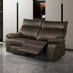 a brown leather reclining sofa sitting in a living room