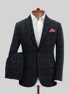 Project your business-like demeanor with a tailored Italian Loza Checks Tweed Suit that conservatively resembles luxury. Crafted with a wool blend, our suit has a solid and stylish plaid pattern of slight green checks over a royal blue framework that will become a favorable piece in your closet. Also, this piece has a comfort feature which is the essence of any couture. So don our suit that fulfills your wish to be in the spotlight on any occasion. 
 
 Look features a 2 button jacket with notch Fitted Green Wool Suit, Green Fitted Wool Suit, Green Tailored Tweed Jacket With Notch Lapel, Formal Tailored Plaid Tweed Jacket, Tailored Green Tweed Jacket For Business, Tailored Plaid Tweed Jacket For Formal Occasions, Business Plaid Tweed Jacket, Green Tweed Jacket With Notch Lapel For Business, Green Wool Suit With Suit Collar