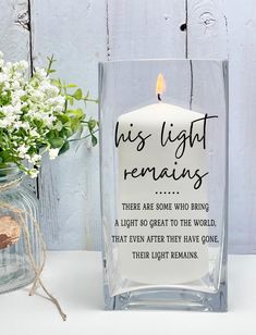 a candle that is sitting next to a vase with flowers in it and the words, his light remains are some who bring a light to the world