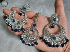 We are thrilled to introduce our exquisite collection of Indian earrings in Silver and Navy Blue. These stunning earrings are crafted to enhance your style, whether you're attending a party or a wedding ceremony. They are guaranteed to make you stand out in the crowd.Elevate your style with these stunning Earrings. Make a bold fashion statement and turn heads wherever you go. Shop our stunning collection today!We have a wide range of colors available, so be sure to check our other listings to find the perfect match for your style. In addition to this earring, we have a wide variety of Indian Pakistani jewelry. Explore our shop to discover the perfect piece for your collection. If you're having trouble viewing our photos, try increasing your screen brightness for a clearer image.We aim to d Blue Danglers For Party, Blue Hand Set Earrings For Party, Blue Hand Set Round Earrings, Hand Set Blue Bridal Earrings For Wedding, Hand Set Round Blue Earrings, Hand-set Blue Bridal Earrings For Wedding, Blue Chandbali Bridal Earrings, Blue Round Chandelier Earrings For Party, Elegant Blue Earrings For Festive Occasions