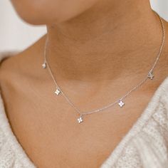 This delicate chain necklace is made from 18 karat gold-plated sterling silver and features five tiny charms attached to its front edge, each one made from four round zirconia arranged like a small flower. It closes at the center back with a spring clasp along with an extension chain, making the overall length adjustable. Stylish and feminine, this piece will suit small prints, flowy blouses and tiered summer dresses. 🎁 Packaging: Beautifully packed in a box, ready for gifting. Details: ✅ Material: 925 sterling silver with 18K gold plated or 18K rose gold plated, cubic zirconia ✅ Length: 41.0 cm (16.14 inches) + 5.0 cm (1.96 inches) extension ✅ Charm size: 5.9 mm (0.23 inches) ✅ Available in gold and rose gold 🏷️ This product is made of sterling silver -- easily recognizable by its '925' Dainty Silver Jewelry, Dainty Jewelry Silver, Mom Makeover, Silver Neckalce, Tiny Charms, Chain Making, Tiny Charm, Flower Pendant Necklace, Delicate Chain