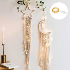 two wall hangings decorated with white lights and greenery, one has a crescent moon and the other is a star