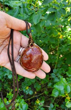 Add a pop of color to your outfit with our Chunky Large Orange Wire Carnelian Pendant. This stylish and versatile accessory is perfect for layering and can be paired with any outfit. Made with a sturdy brass wire, this eye-catching pendant showcases the natural textures and polish of the Carnelian stone. Enhance your style with this unique statement piece today!! Please view all of the photos for details and choose your chain length at checkout. Choose your cord/chain material at checkout.  All Wire Wrapped Teardrop Agate Jewelry, Teardrop Agate Wire Wrapped Jewelry, Brown Teardrop Jewelry For Gift, Copper Wire Teardrop Pendant Jewelry For Gift, Copper Wire Teardrop Pendant Jewelry Gift, Spiritual Hand Wrapped Teardrop Pendant Necklace, Brown Teardrop Gemstone Jewelry, Artisan Hand Wrapped Teardrop Necklaces, Teardrop Healing Jewelry Wire Wrapped