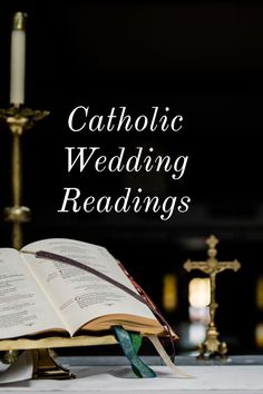 an open book sitting on top of a table next to a candle and some candles