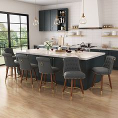 a large kitchen with wooden floors and blue cabinets