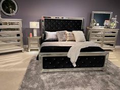 a large bed sitting on top of a carpeted floor next to two dressers