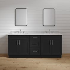 two sinks and mirrors in a bathroom with wood flooring, white walls and wooden floors