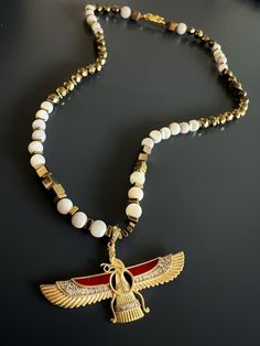 The Faravahar Necklace is simple yet stylish with strong energy. I design all my jewelry with different stones and symbols with the intention of bringing something positive to the owner's life . This most powerful spiritual symbol old more than 4000 years. Faravahar Symbol found in Egypt and Mesopotamia and represent power. There is three simple idea abut life'' Good thoughts, Good words, Good deeds”, I personally hand craft each piece, making them one of a kind and meaningful...Each piece is un Spiritual White Beaded Pendant Necklace, Spiritual White Pearl Necklace With Pendant, White Spiritual Pendant Pearl Necklace, Collectible Spiritual Pendant Jewelry, Spiritual Pendant Beads Polished, Spiritual Transformation, Spiritual Symbols, Coral Stone, Spiritual Guidance