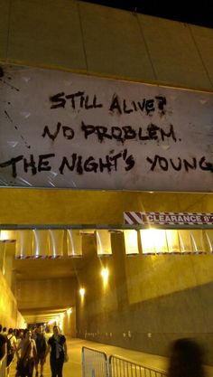 a sign that says still alive, no problem the night's young on it