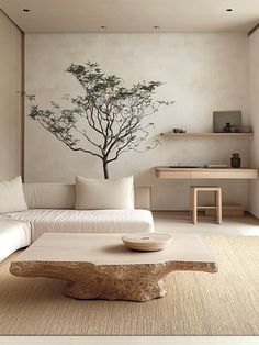 a living room with white furniture and a tree painted on the wall above it's coffee table