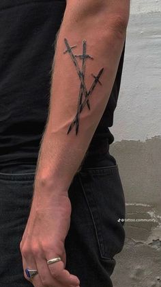 a man with a tattoo on his arm holding two swords in one hand and an arrow in the other