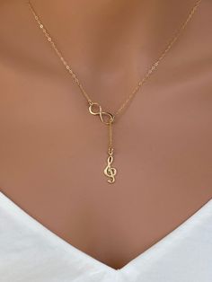 Sterling silver music charm necklace. Sterling Silver Treble Clef Music Charm. The perfect silver charm for music lovers and musicians. Sterling Silver Music Note Charm - Treble Clef 18x7mm This necklace is made of.... -18x7 S24k gold fill Music Note Charm - Treble Clef, -Gold plated on Sterling Silver infinity charm, -14k Gold Fill cable chain with spring clasp, -Come up with beautiful ribbon gift box and -One set of Care instruction package. MORE RELIGION NECKLACES https://www.etsy.com/shop/ra Music-themed Charm Jewelry As A Gift, Music-themed Charms Jewelry For Gifts, Music-themed Charms Jewelry As Gift, Music-themed Jewelry Charms For Gifts, Music Note Jewelry, Piano Teacher Gift, Music Necklace, Gift For Musician, South San Francisco