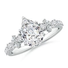 a diamond engagement ring with three stones on the band and an oval shaped center stone