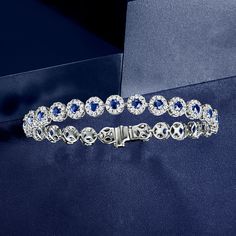 Ross-Simons - 5.50ct t. w. Sapphire, 3.00ct t. w. Diamond Tennis Bracelet. 8". A truly stunning showpiece, this tennis bracelet sparkles and shines with 5.50 ct. t. w. sapphire rounds, surrounded by 3.00 ct. t. w. round brilliant-cut diamonds. The perfect complement to your fanciest night-out ensemble! Set in polished 14kt white gold. Single-latch safety. Box clasp, diamond and sapphire tennis bracelet. Sapphire birthstones are the perfect gift for September birthdays. Luxury Tennis Bracelet With Halo Setting For Formal Events, Luxury Tennis Bracelet With Halo Setting For Formal Occasions, Formal White Gold Tennis Bracelet With Halo Setting, Formal Fine Jewelry Tennis Bracelet With Halo Setting, Classic Formal Tennis Bracelet With Halo Setting, Classic White Gold Tennis Bracelet With Halo Setting, Fine Jewelry Tennis Bracelet With Halo Setting For Anniversary, Formal Diamond Tennis Bracelet With Halo Setting, Diamond Tennis Bracelet With Halo Setting For Formal Occasions