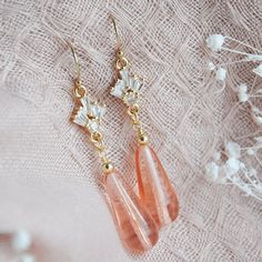 "These beautiful art deco earrings are created with wire wrapped dusty pink glass teardrops and accented with tiny cubic zirconia fans. These are secured to dainty 14k gold filled earring wires for a comfortable all day wear. These simple yet elegant pink wedding earrings are the perfect beach wedding, rustic wedding accessory for your bridesmaids and compliment many boho bridal attire adding a dose of subtle glam to your wedding day. Your boho bridal earrings will arrive suitably gift wrapped r Pink Wedding Earrings, Blush Pink Earrings, Boho Bridal Earrings, Subtle Glam, Bridal Attire, Deco Earrings, Wedding Accessory, Earring Wires, Wedding Rustic